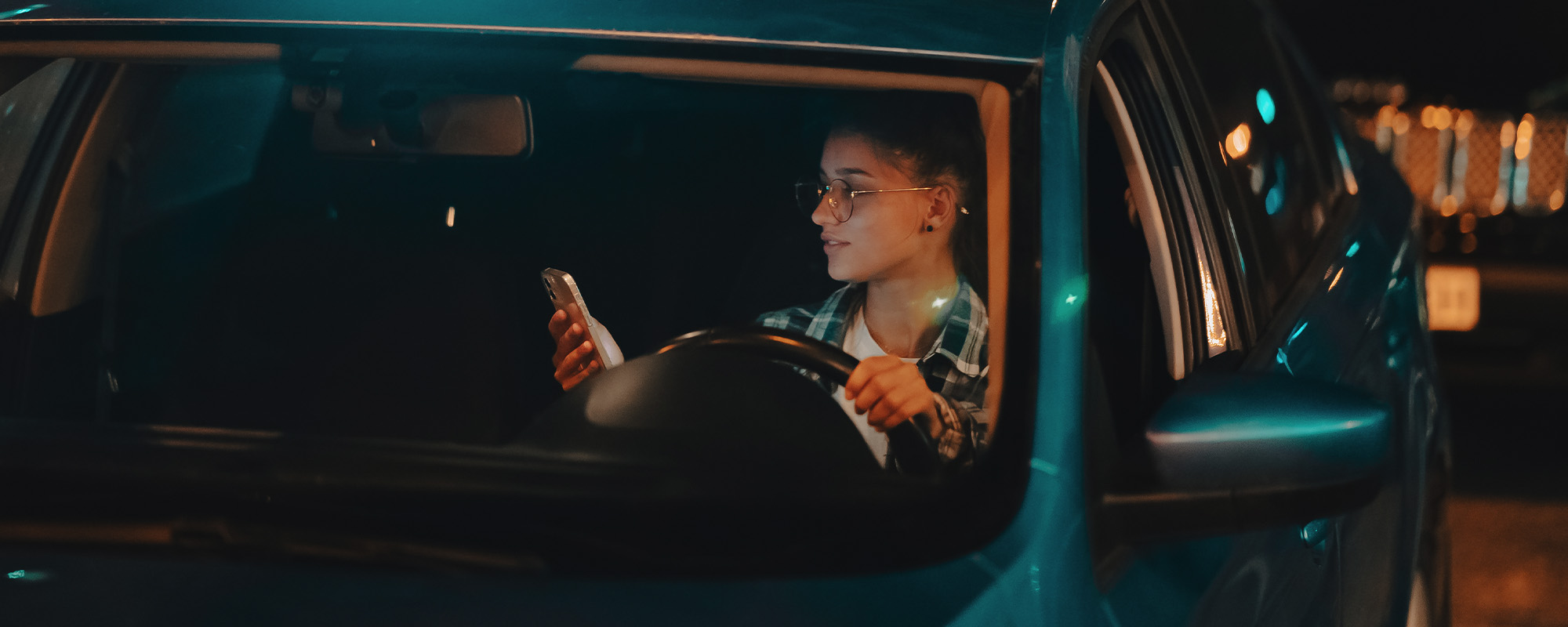 lost female driver using mobile phone while driving at night.