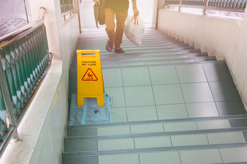wet floor sign on stairs