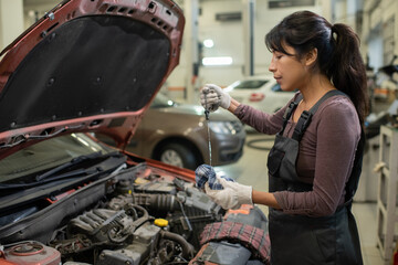 woman working on car engine