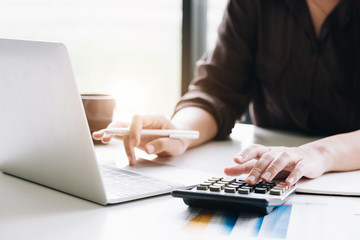 woman with calculator and computer