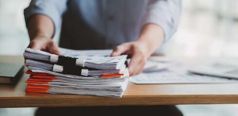 man holding stacks of evidence and documentation