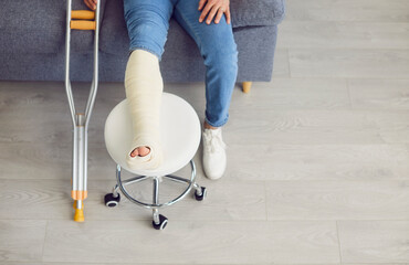 legs and feet of woman on couch with broken foot