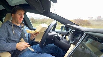 man eating while driving reckless