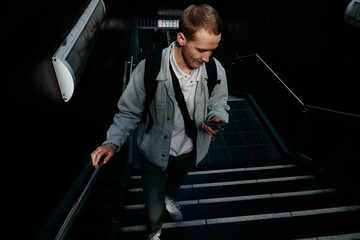 man walking on stairs with phone
