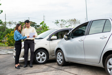 two people exchanging information after a car accident